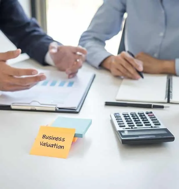 Professionals preparing a business valuation report for strategic planning.