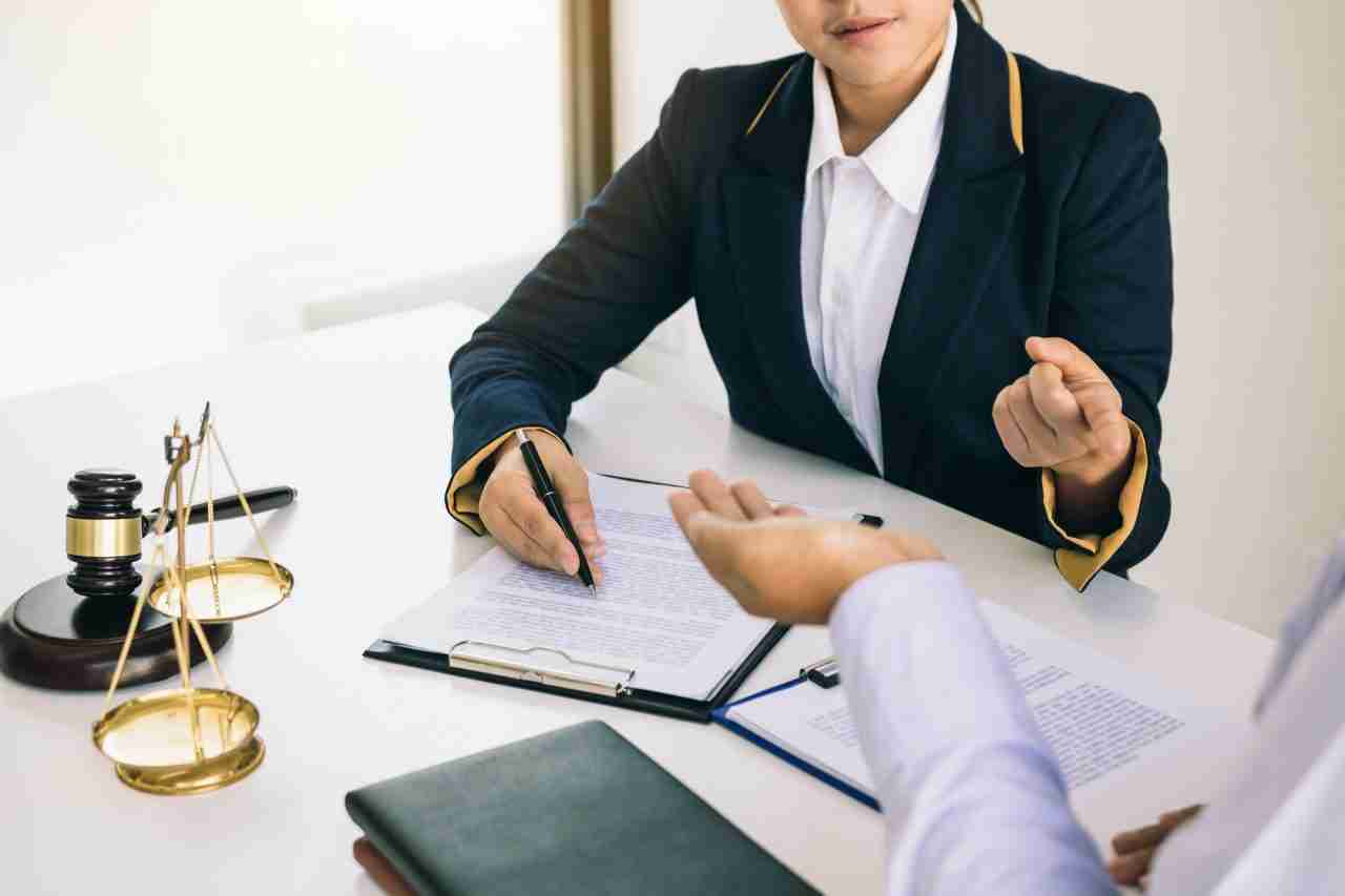 Lawyer providing legal guidance – Reviewing legal offenses and regulations from law book